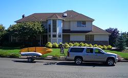 Our Chevy Suburban with the katak trailer connected, parked in front of the new house.