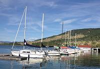 In the foreground, The Anne Marie pictured in her slip at Flathead Lake Montana awaiting an afternoon sailing session.